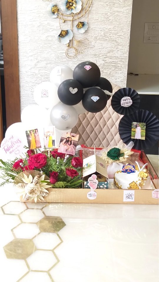 Blue and white birthday hamper filled with chocolate, flowers, and photo details