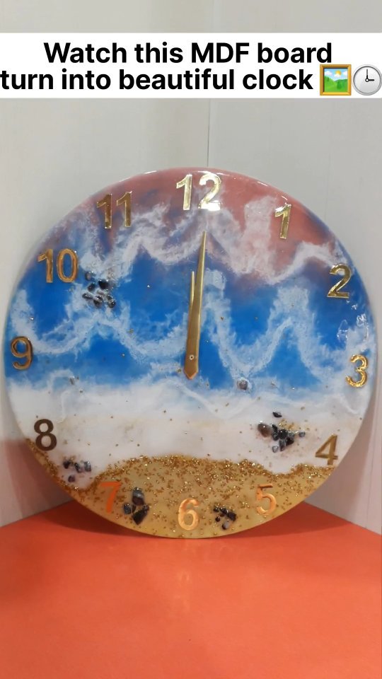 Blue and gold resin clock with a cloud-like white centre