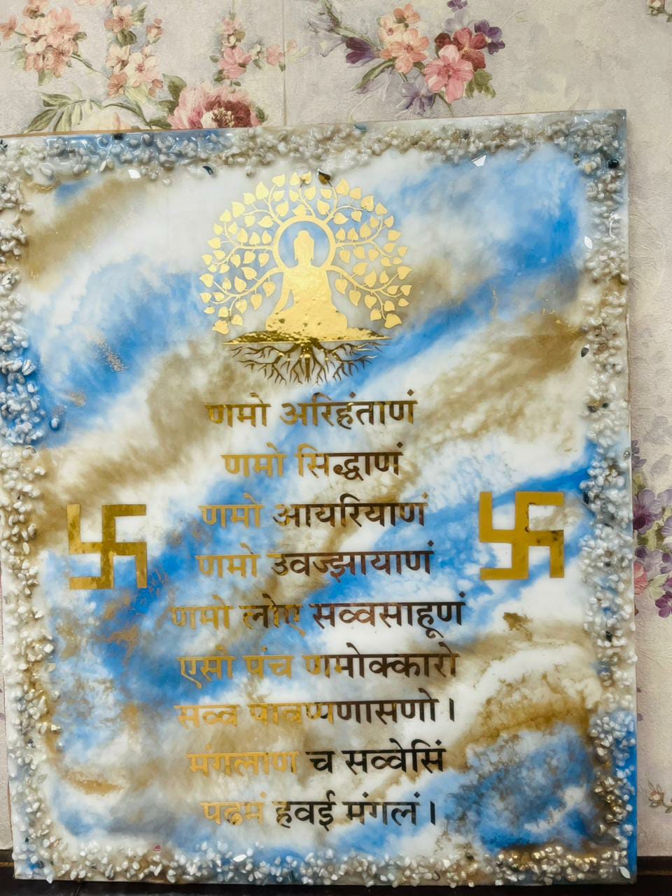 Blue and white resin frame with a gold Namokar mantra design and textured stone border