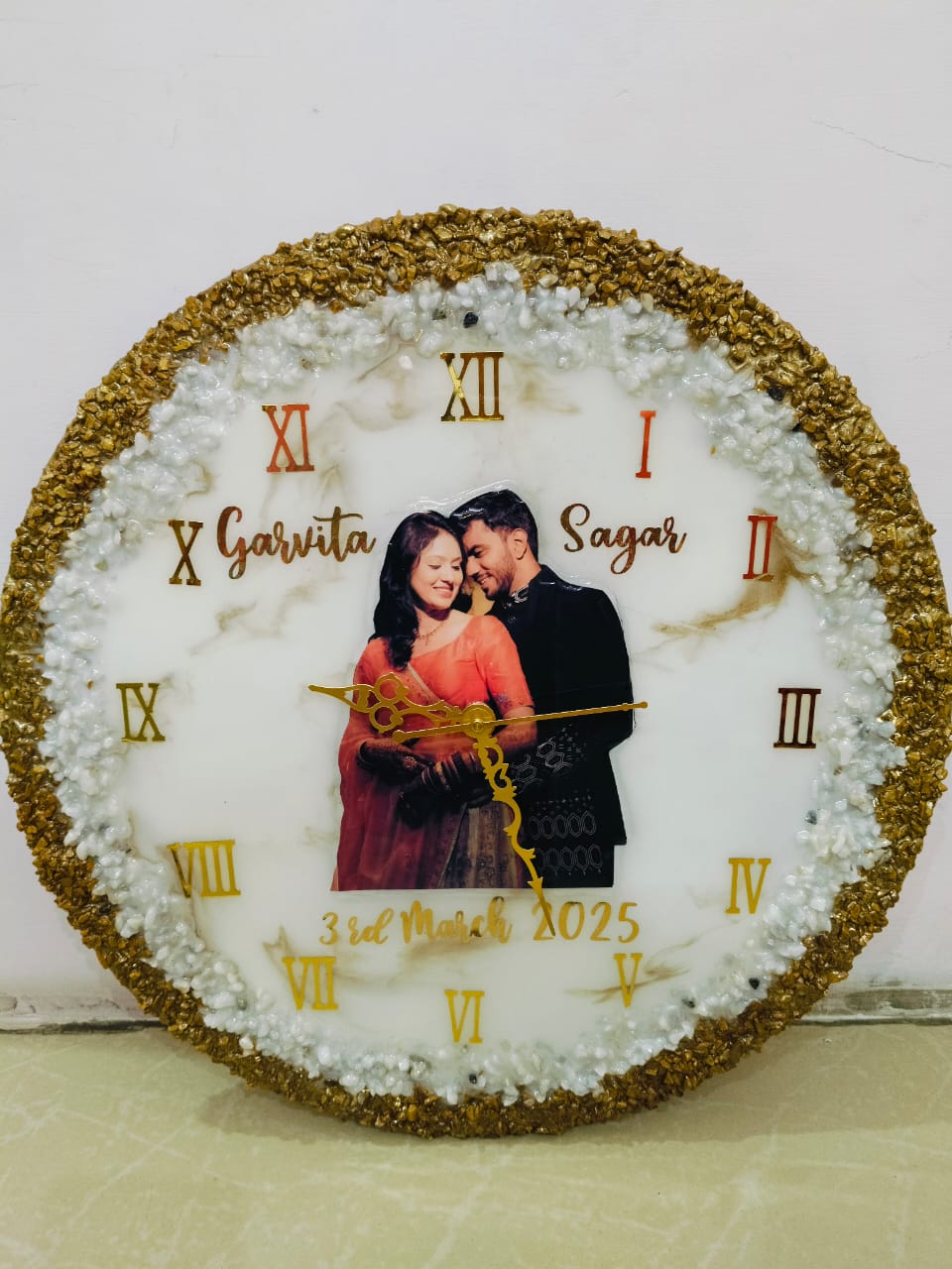 Round white and gold resin photo clock with a couple's picture and gold numerals